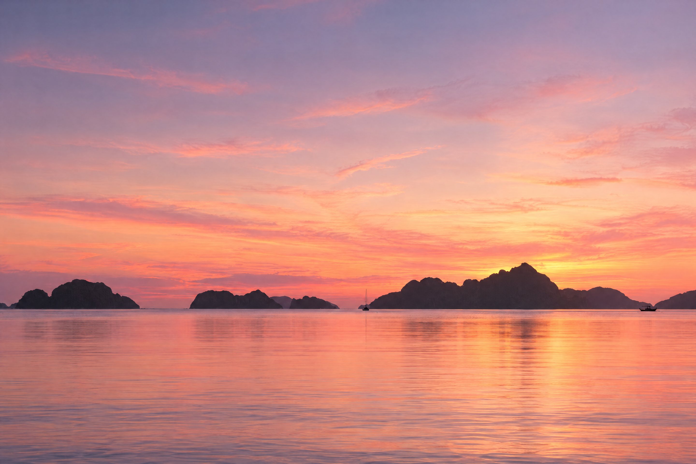 Islands silhouetted at twilight in Bacuit Bay